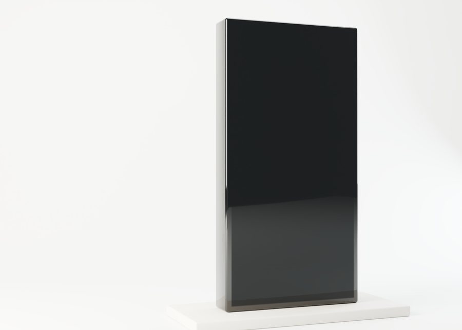 A monolith of polished black glass, the black mirror, standing in a pale daylight studio; a live security console glows on its face.